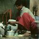 Chitra doing dishes in her home outside of Cuddalore.